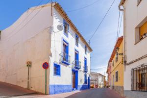 a street in a town with blue and white buildings at La Cambra de la Clau in Polop