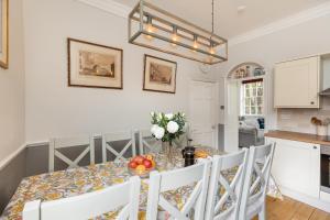 a kitchen and dining room with a table and chairs at 6 Bedroom City Centre Georgian Town House - Abbey & Baths-2 min walk in Bath
