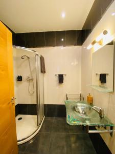 a bathroom with a sink and a shower at Casa Naranja - Centrally located, spacious, unique in Donostia-San Sebastián +9 photos