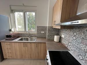 a kitchen with a sink and a window at River Home in Agia Galini