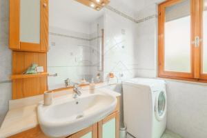 a bathroom with a sink and a washing machine at A Casa di Zaira - Goelba in Portoferraio