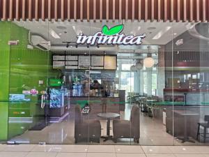 a fast food restaurant with a table and chairs at Love@Grace Residences near BGC. in Manila