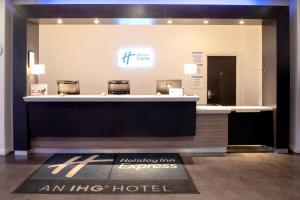an hilton hotel lobby with a reception desk at Holiday Inn Express Manchester City Centre Arena, an IHG Hotel in Manchester