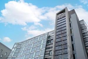 a building with a sign on the side of it at Holiday Inn Express Manchester City Centre Arena, an IHG Hotel in Manchester