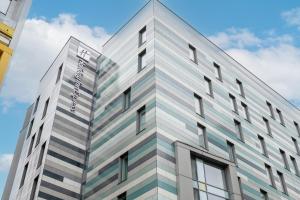 a rendering of the exterior of a building at Holiday Inn Express Manchester City Centre Arena by IHG in Manchester