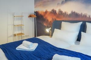 a bedroom with a bed with a towel on it at 7Seas City-Apartment Kaiserslautern - Balkon l NETFLIX l 24h Self Check-in in Kaiserslautern