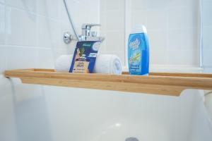 a shelf with towels and a bottle of toothpaste at 7Seas City-Apartment Kaiserslautern - Balkon l NETFLIX l 24h Self Check-in in Kaiserslautern