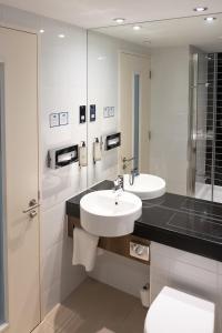 a bathroom with a sink and a toilet and a mirror at Holiday Inn Express Manchester City Centre Arena by IHG in Manchester