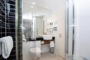 a bathroom with a toilet and a sink and a shower at Holiday Inn Express Manchester City Centre Arena by IHG in Manchester