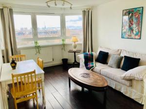 a living room with a couch and a table at A Skyhigh Stay for 2 in Vauxhall London in London