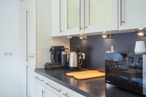 a kitchen with a coffee maker on a counter at 7Seas City-Apartment Kaiserslautern - Balkon l NETFLIX l 24h Self Check-in in Kaiserslautern