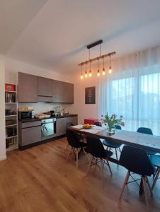 a kitchen and dining room with a table and chairs at La residenza del viale in Treviglio
