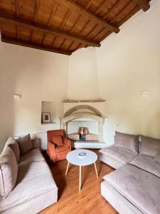 a living room with two couches and a table at Cozy village house in Ano Asites in Áno Asítes