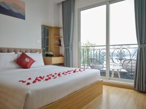 a bedroom with a bed with red roses on it at MoonLight Tay Ho in Hanoi