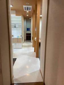 a hallway of a bathroom with a sink and a tub at Minowa airbnb in Yubari