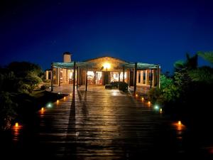a building with lights on a dock at night at Villa Claire in Toliara