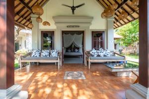 a living room with two couches and a fireplace at Villa Santai Pemuteran in Pemuteran
