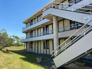 an external view of a building with stairs at Premiere Classe La Rochelle Sud - Angoulins in Angoulins