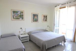 Postel nebo postele na pokoji v ubytování Residence Hotel Villa Mare