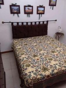 un letto in una camera da letto con immagini appese al muro di Casa Stornello a Favignana