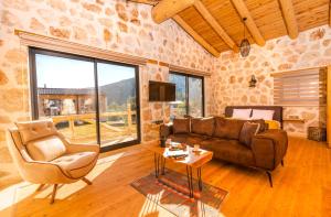 a living room with a couch and a table at Sedir Taş Evleri in Kalkan