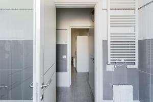 a bathroom with a walk in shower and a toilet at Le Marine Apartments in Bisceglie
