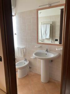 a bathroom with a sink and a mirror at Casale degli Ulivi in Roccadaspide +19 photos