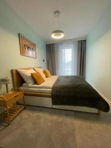 a bedroom with a large bed and a window at Harry’s Apartment/centrum/parking in Wrocław