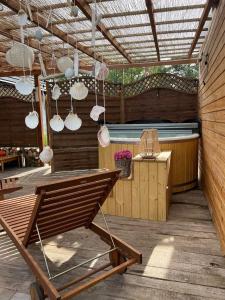 a patio with a table and a bench and lights at Apartament z antresolą in Okszów