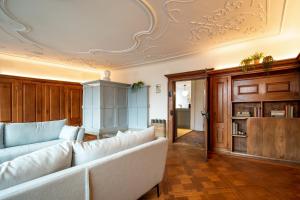 a living room with a couch and a ceiling at JACOB 1808. fine historic town apartments in Bischofszell