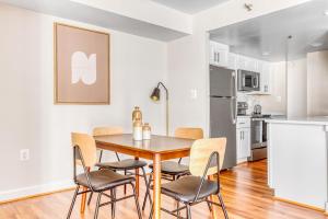 a kitchen and dining room with a wooden table and chairs at Ballston 2BR w Concierge WD Pool nr Metro WDC-504 in Arlington