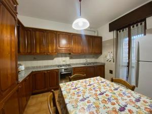 a kitchen with a table with a flowered table cloth at Fronte Fiera Apartment in Pero
