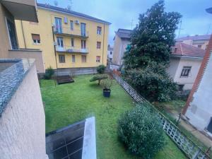 un patio trasero con césped y un edificio en Fronte Fiera Apartment, en Pero