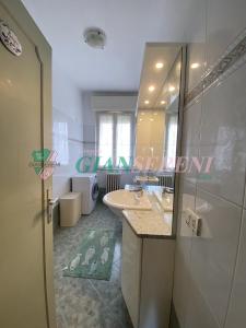 uma casa de banho com um lavatório, uma banheira e um espelho. em CorsoItalia43c em San Vincenzo