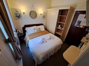 a hotel room with a bed with two stuffed animals on it at Lily Hotel in Blackpool