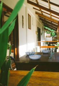 a table with bowls and plates on top of it at Casa De Loren in General Luna