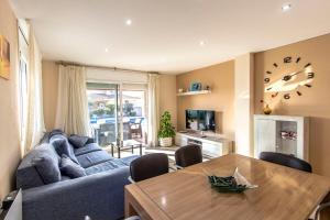 a living room with a blue couch and a wooden table at Catalunya Casas Costa Brava Relax and Recharge 20km from beach! in Sils