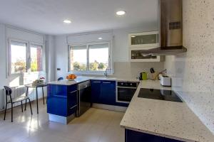 a kitchen with blue cabinets and a counter top at Catalunya Casas Costa Brava Relax and Recharge 20km from beach! in Sils