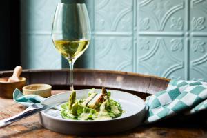 a plate of food and a glass of white wine at Kasteel Kerckebosch in Zeist