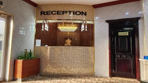 a lobby of a hotel with a sign that reads reception at Ruwi Beach Hotel Apartments - MAHA HOSPITALITY GROUP in Sharjah