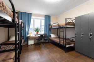 a dorm room with bunk beds and a desk at Хостел єЖитло Щекавиця in Kyiv