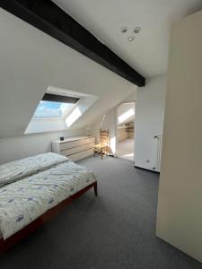 a white bedroom with a bed and a window at Nachtquartier Münster in Münster