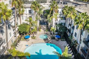 an overhead view of a pool in a building with palm trees at Marina Del Rey Resort Style Apartment I Free Parking in Los Angeles