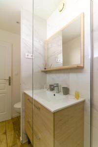 a bathroom with a sink and a mirror at SELECT'SO HOME - T2 au cœur du Lavandou - Prestations de qualité - GAIA in Le Lavandou