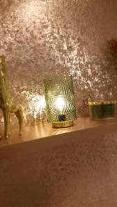 a candle in a glass jar on a shelf at Lyme View Lodge in Trent Vale