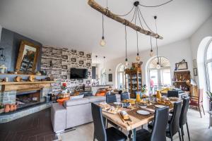 a living room with a table and a fireplace at Panacea la casa del miele in Santa Maria di Castellabate