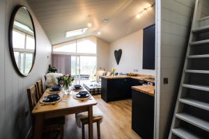 a kitchen and dining room in a tiny house at Buck Barn in Nantmel