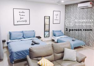 a bedroom with two beds and a couch at Netflix WiFi Cozy Homestay Trefoil Setia Alam Shah Alam 沙亚南舒适温馨日租民宿 in Setia Alam