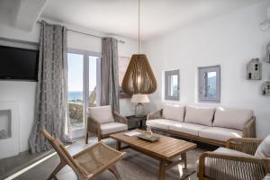 a living room with a couch and a table at Alfa Luxury Villas in Chrissi Akti