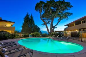 a swimming pool with chairs around it at night at The Pierpont Inn in Ventura